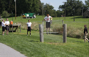 Explorer Members Climbing a Fence